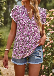 Detailed close-up of V-neck floral top with white lace hem and elegant fuchsia patterns