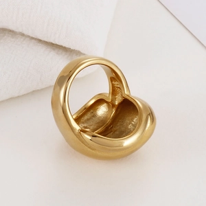 Close-up of golden stainless steel ring featuring a thick minimalist fishnet organic shape