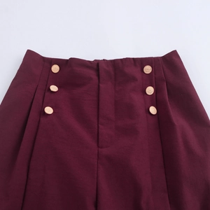 Burgundy high-waisted straight leg trousers with double-breasted gold button details