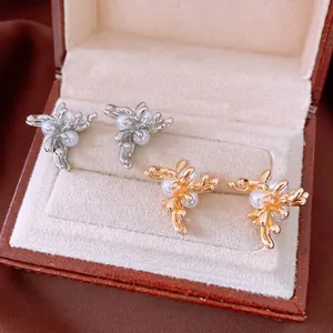 Elegant French style gold and silver branch earrings with small pearls in a jewelry box