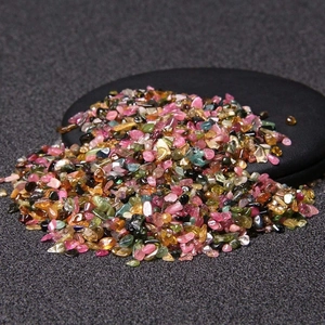 Polished natural crystal quartz gravel mix on a black mat for healing and decoration