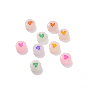 Detailed view of colorful heart pattern beads for handmade jewelry and DIY crafts