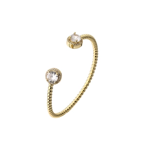 Detail of adjustable gold bangle with zircon studs and beaded texture edges