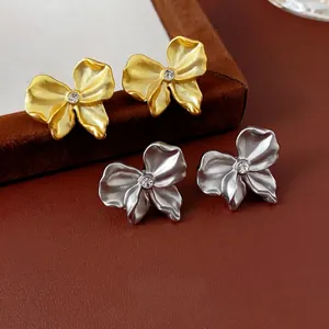 Elegant floral stud earrings in matte gold and silver with sparkling zircon accents