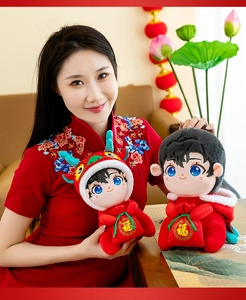 Detail of 2024 Year of the Dragon plush mascot dolls held by a model in a red dress