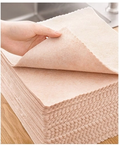Close-up of textured beige non-woven cleaning cloths showing fiber density and thickness