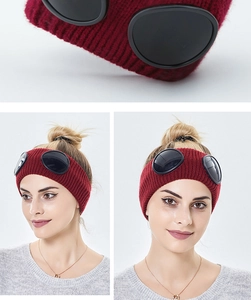 Close-up of burgundy knit headband with integrated black goggle lenses for outdoor style