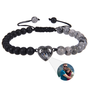 Detail of heart projection charm with personalized photo feature on beaded stone bracelet