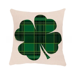 Detail of shamrock pillow cover with green plaid pattern on beige linen fabric