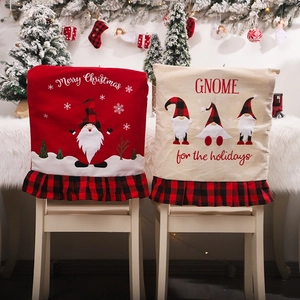 Christmas gnome chair covers with red and beige pleated skirts for holiday dining decor