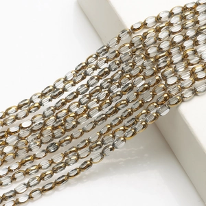 Macro shot of 4x6mm oval transparent glass beads with gold trim for DIY jewelry making