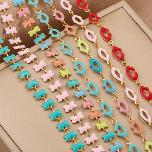 Colorful enamel lip charm bracelets in gold finish displayed in a beige jewelry gift box