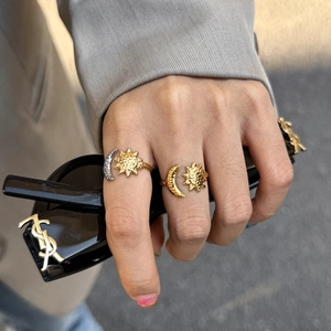 Detail of sun and moon rings with hammered texture and two-tone vintage finish