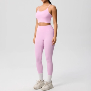 Detail of pink high-stretch yoga set featuring thin straps and high-waisted seamless leggings