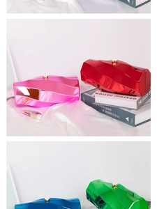Detail of geometric acrylic clutch bags in metallic pink, red, blue, and green finishes