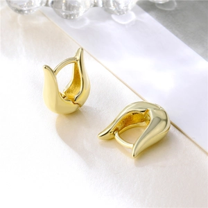 Minimalist gold U-shaped polished earrings shown on a premium cream display tray
