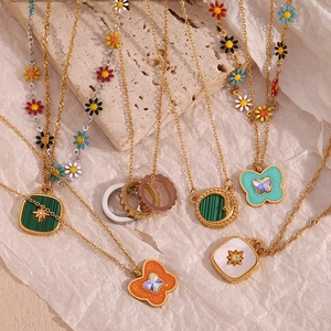 Flat lay of 18K gold plated necklaces featuring butterfly and star shell pendants