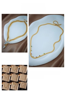 Close-up of golden multi-layer necklaces featuring pearl and heart pendants on satin