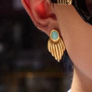 18K gold plated stainless steel leaf earrings with light blue oval stone on model