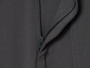 Macro detail of high-quality dark fabric and matching nylon zipper on dress pants