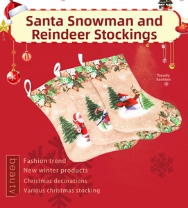 Detail of Christmas stocking set with Santa and reindeer prints on rustic fabric