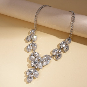 Macro shot of silver crystal leaf statement necklace with shimmering cluster pendants