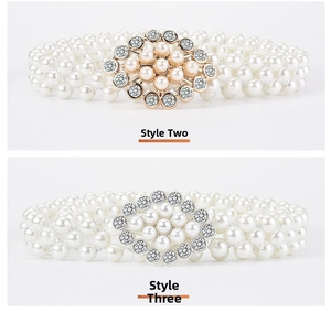 Detail of elegant pearl waist chain belts with flower-shaped rhinestone buckles
