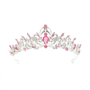Detailed view of pink crystal droplets and silver vine patterns on a luxury bridal crown