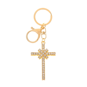 Detail of a golden cross keychain featuring sparkling rhinestones and a lobster clasp