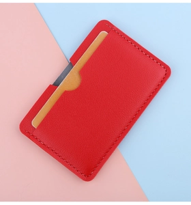 Detail of red lychee grain leather card holder with white contrast stitching