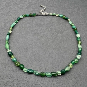 Detail of green natural stone necklace with irregular beads and stainless steel clasp