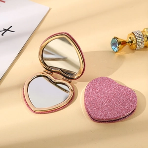 Pink glitter heart-shaped folding makeup mirror showing open and closed positions