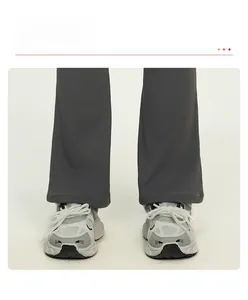 Detail of dark grey flared yoga pants with a wide-leg cut and smooth high-quality fabric