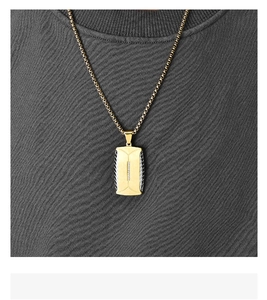 Close-up of men's two-tone tire pattern pendant necklace with stones on a male model