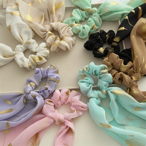 Detailed set of eight colorful chiffon scrunchies with elegant gold feather patterns