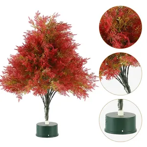 Mini rotating red Christmas tree desk ornament with LED lights and festive pine needles