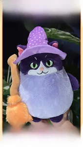 Detail of a purple plush wizard cat with embroidered face and felt broom for Halloween