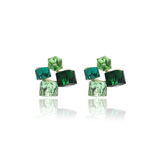 Macro shot of geometric green crystal cube earrings with silver posts and mirror reflections