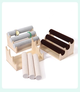 Three-tier wooden bracelet display stands with velvet rolls in grey, beige, and brown