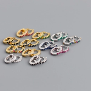 Macro shot of 925 sterling silver hoop earrings with multicolored cubic zirconia stones