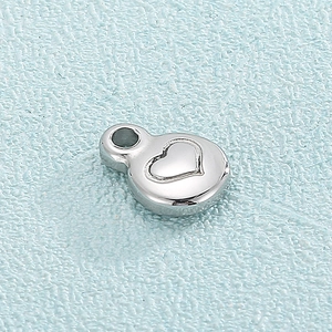 Minimalist silver heart-patterned stainless steel pendant with a polished round finish