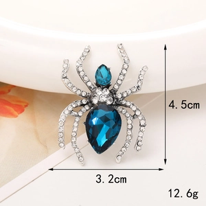 Silver alloy spider brooch featuring blue drop gems and white crystal pavé legs