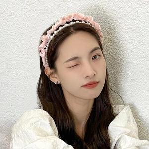 Pink pleated mesh headband with pearls shown on a model for a chic French style look
