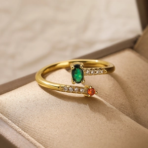 Detail of adjustable 18K gold-plated ring with green oval gem and small zircons