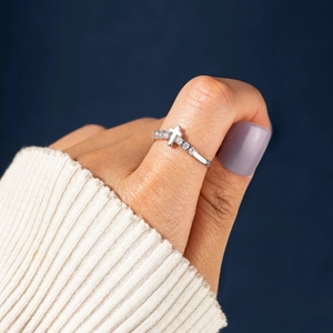 Macro view of S925 sterling silver cross ring with white zircon on thumb