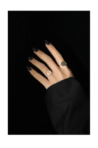 Detail of S925 sterling silver rings with moonstone on a hand over black background