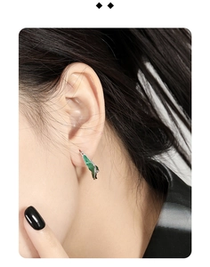 Close-up of elegant S925 silver U-shape earring with green enamel drip on female model