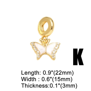 Detailed view of 18k gold butterfly pendant with white enamel and sparkling rhinestones