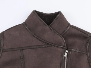 Detail of dark brown faux suede jacket featuring leather piping and silver metal zipper
