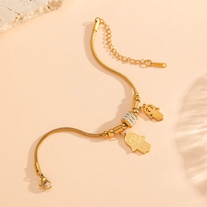 Bracelet en acier inoxydable plaqué or 18 carats avec main de Fatma et strass blancs